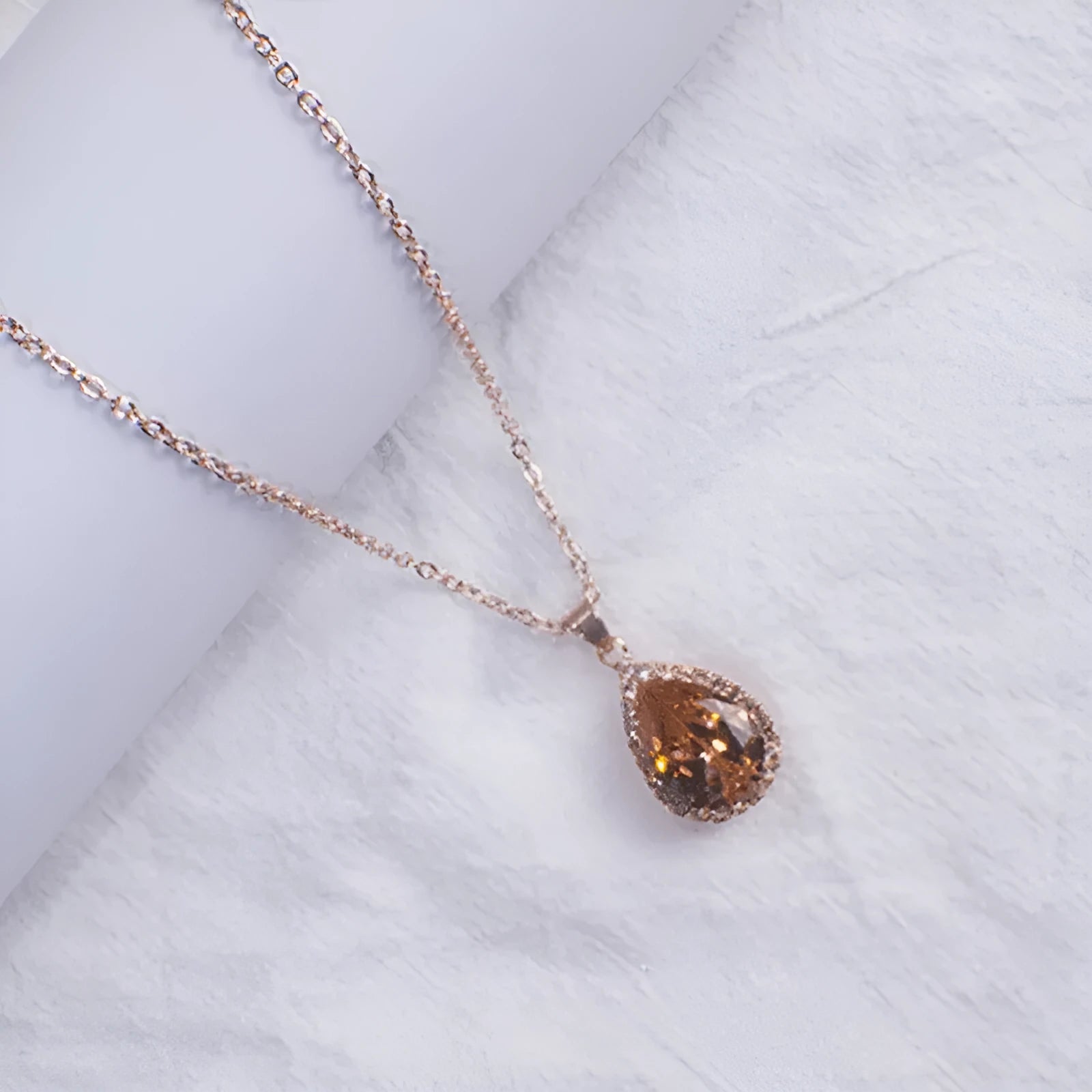 Women's rose gold electroplated rhinestone necklace with geometric water drop pendant in pink colour