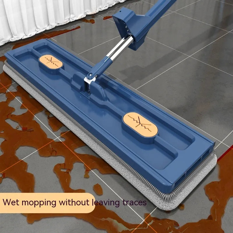 Large blue and white flat mop with a long stainless steel handle and a 360-degree rotating head on a hard floor.