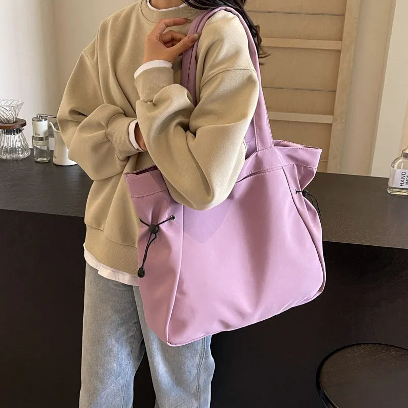 Soft Oxford cloth folding tote bag in a choice of five colours: black, brown, dark grey, light grey, and purple.