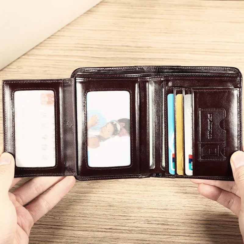 Men's black leather wallet open to show internal card slots, coin pocket, and document sleeve.