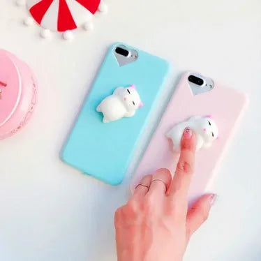 Soft silicone TPU iPhone case featuring a raised 3D cartoon cat design, shown in pink.