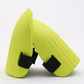 A pair of black EVA foam knee pads for gardening, shown from above on a hard surface.