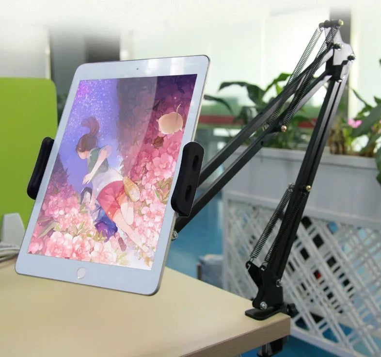 Black adjustable phone tablet stand with 360-degree rotation on wooden table