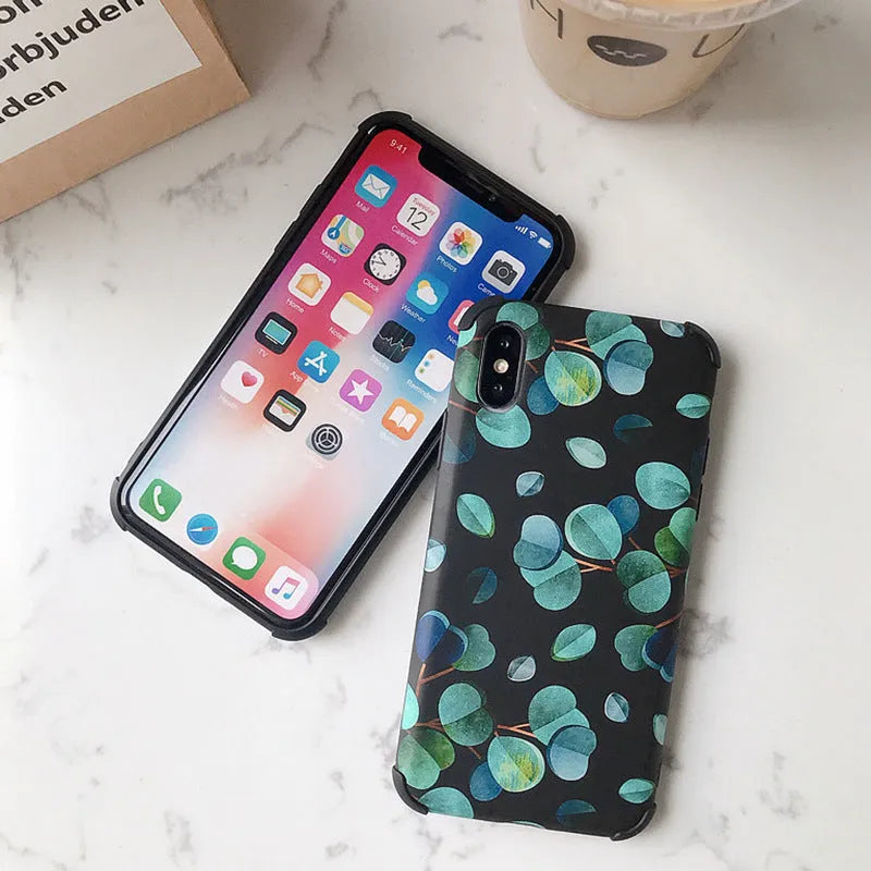Black silicone iPhone case featuring a decorative leaf print design on the back.