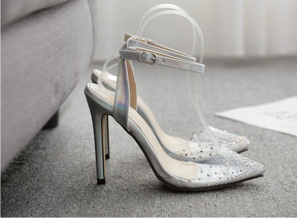 Women's pointed-toe stiletto sandals with a clear PVC upper.