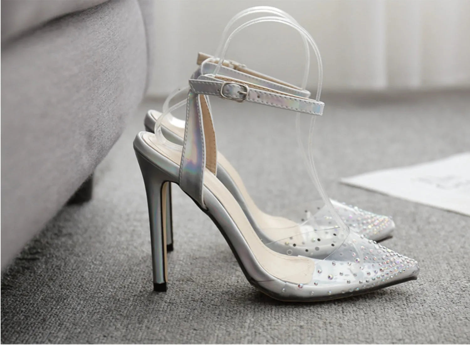 Women's pointed-toe stiletto sandals with a clear PVC upper.