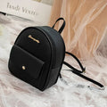 Small black women's PU backpack purse with a zipper, shown with a mobile phone for scale.