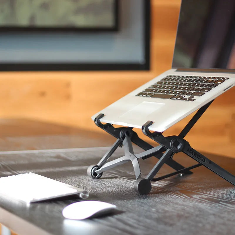 Black folding laptop stand with adjustable height mechanism and reinforced nylon construction