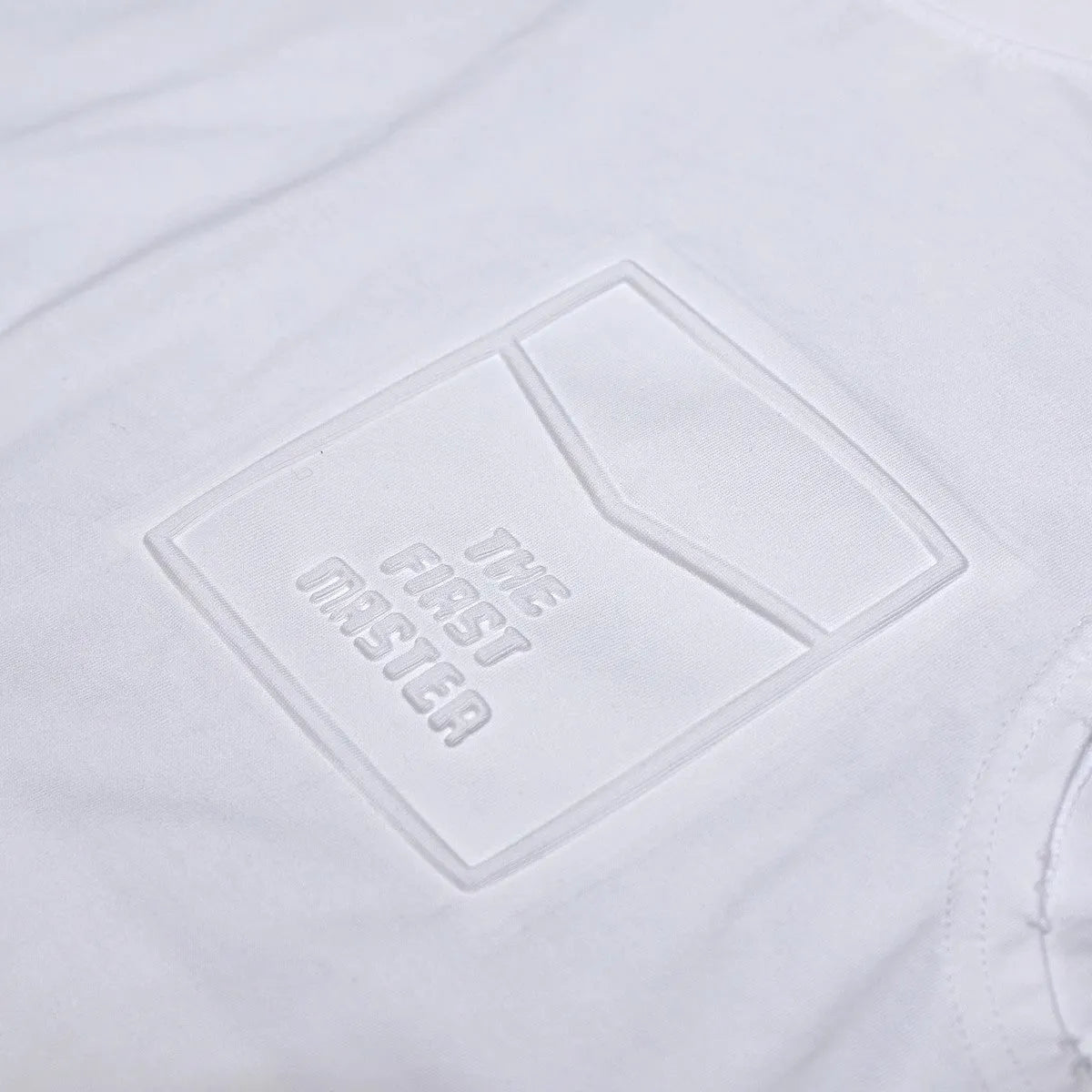 Solid colour loose cotton sleeveless t-shirt on a hanger in white or black