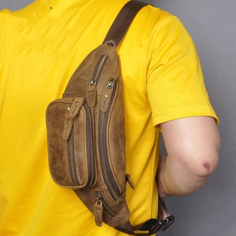 Retro brown leather messenger bag with single shoulder strap shown open.