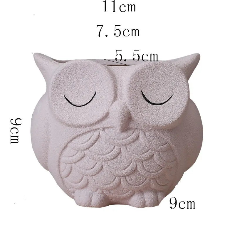 Handmade ceramic owl-shaped succulent plant pot in frosted light pink, shown from the front.
