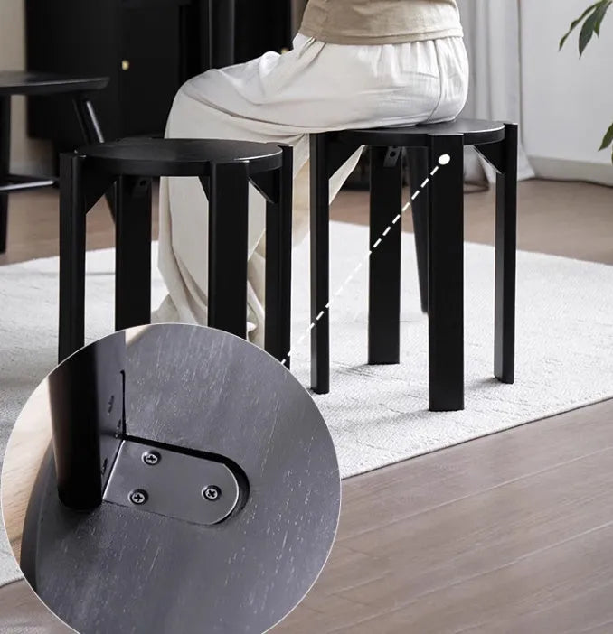 Stackable round iron dining stool in a modern design, shown in a choice of colours.