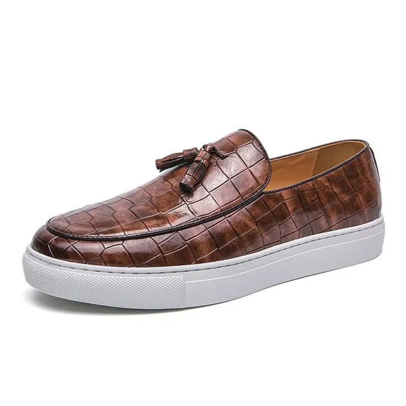 Men's black tassel detail slip-on sneakers with a round toe and rubber sole.