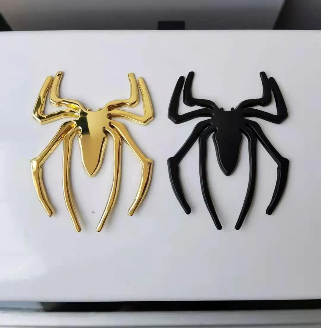 Gold 3D metal spider bumper sticker on a car bumper