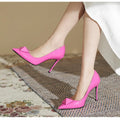 Pink patent leather women's stiletto heels with pointed toe, ankle strap buckle and rivet details.