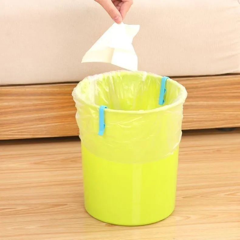 Transparent plastic non-slip clip for holding a garbage bag on the rim of a bin.
