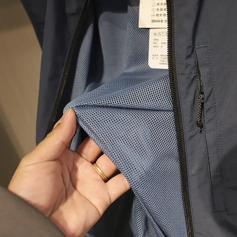 Men's straight cut nylon vest in army green with side seam pockets on a hanger.