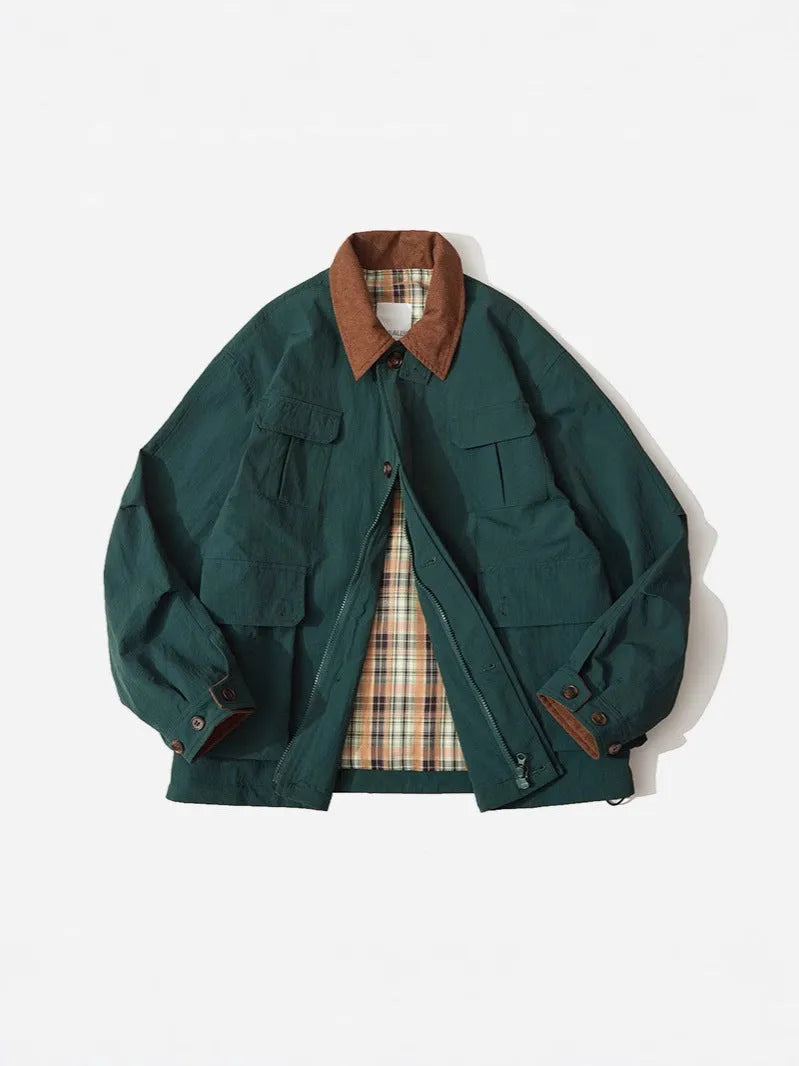 Green casual polyester jacket for men and women with side pockets on a hanger.