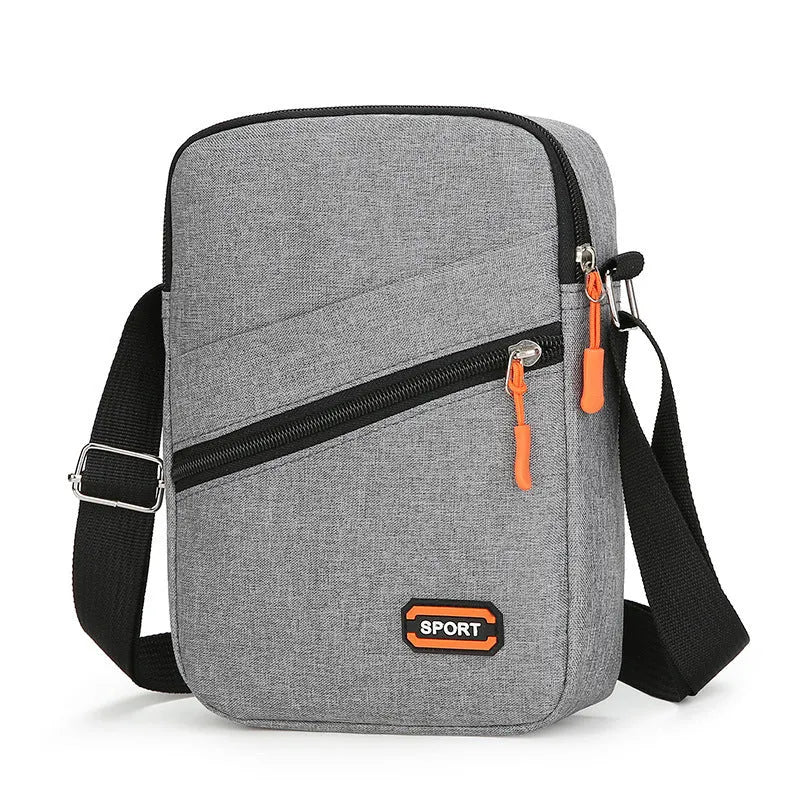 Lightweight Oxford cloth crossbody commuter bag in a solid colour with contrast detail.