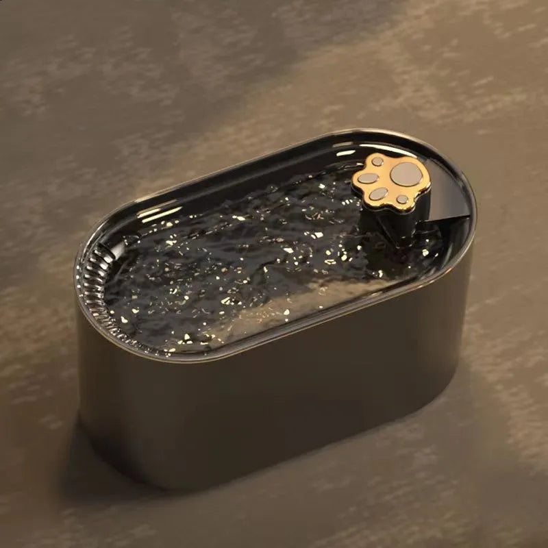 Blue automatic pet water fountain with filter on a floor next to a cat