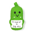 Green pickle-shaped dog chew toy with textured surface and squeaker for teething puppies
