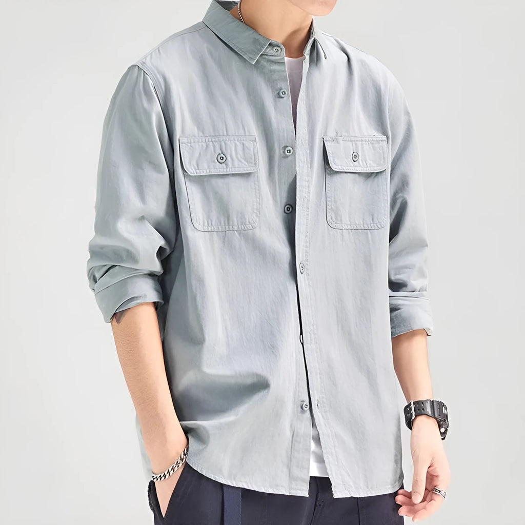 Man wearing a loose fit long sleeve overalls shirt in polyester, cardigan style.