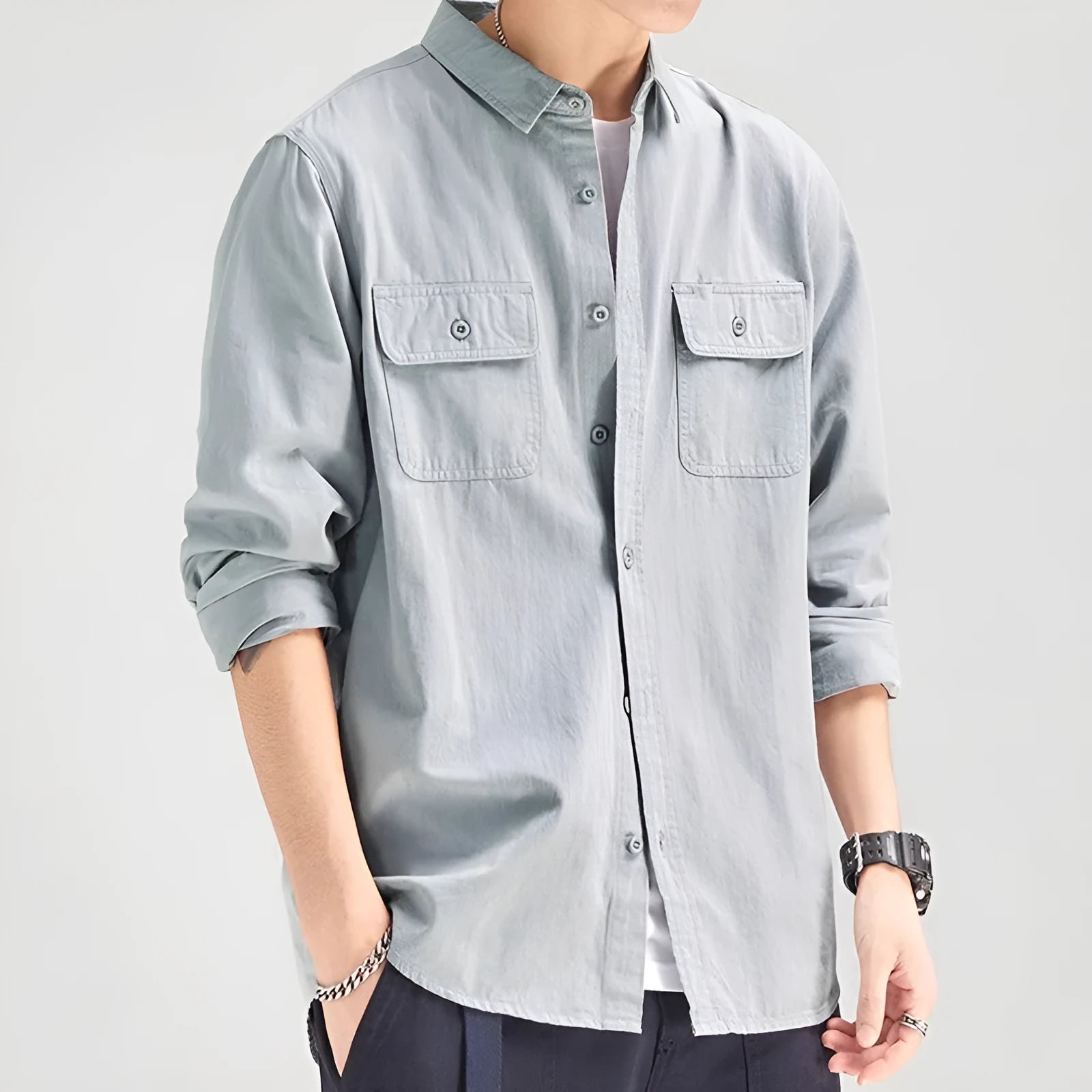 Man wearing a loose fit long sleeve overalls shirt in polyester, cardigan style.