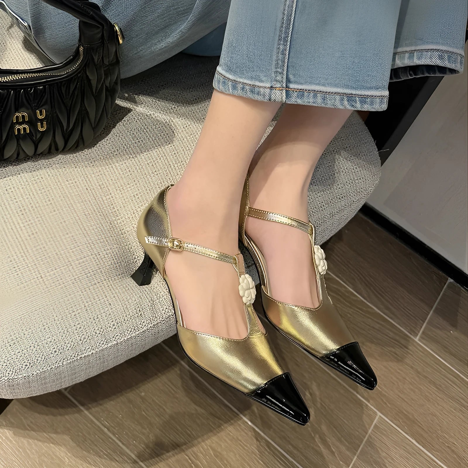 Women's black stiletto heel with pointed toe, floral detail, and a shallow mouth cut.