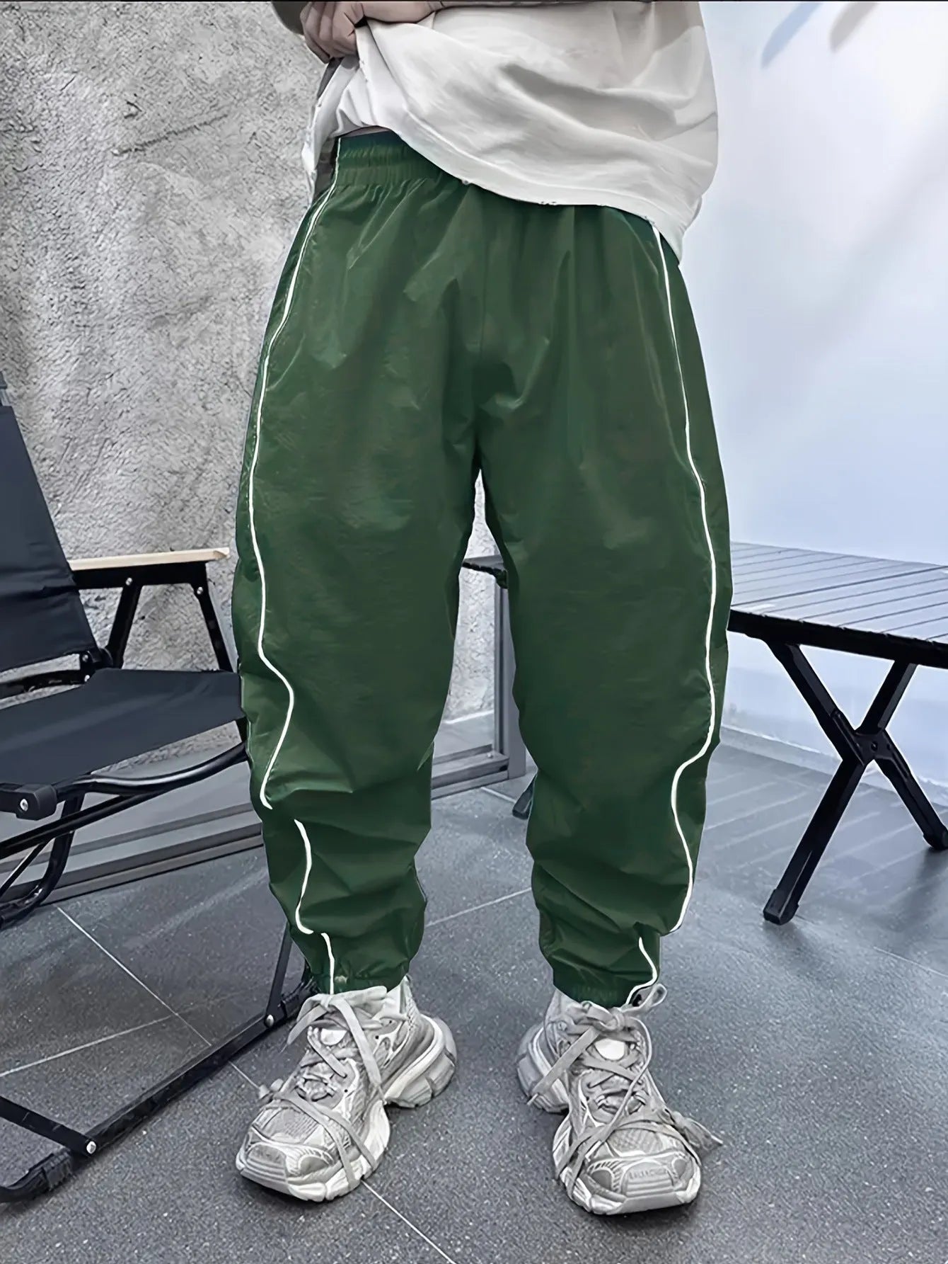 Man wearing blue loose-fit cropped sports trousers made from bamboo fibre.