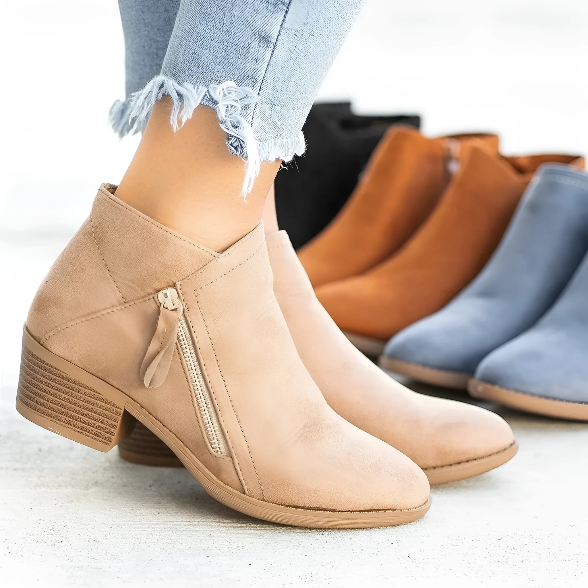 Women's blue suede ankle boots with side zip and chunky heel on a white background
