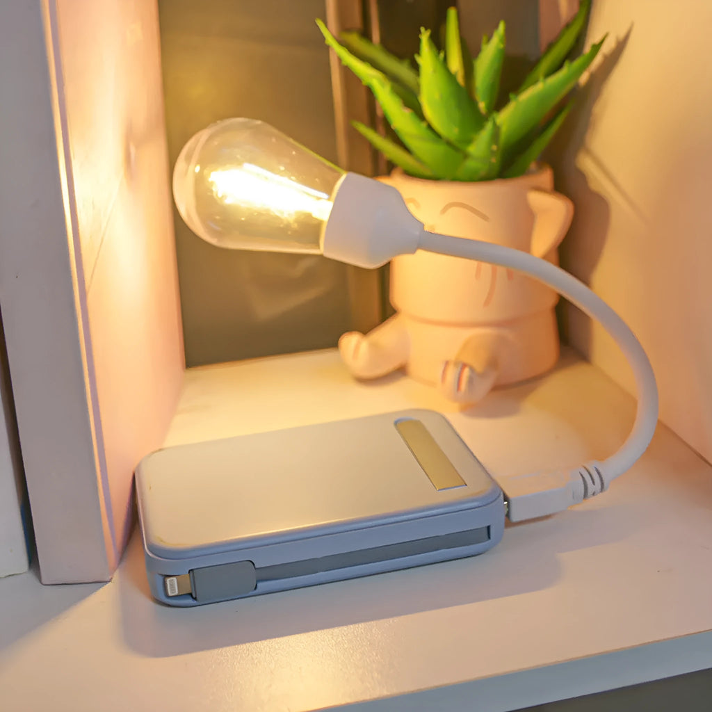 Folding USB rechargeable night light with glowing tungsten filament bulb.