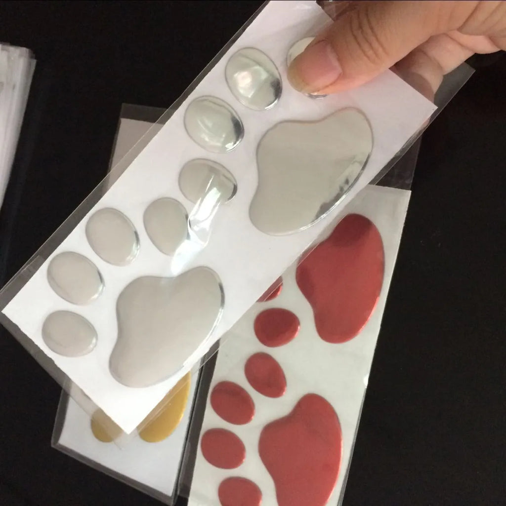 Hand-shaped brush dog footprint car sticker in red, silver, gold, and black colour options.