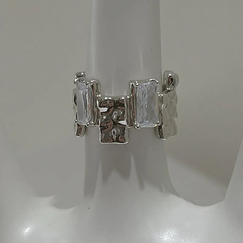 Silver geometric cross ring with zircon detailing and open gemstone setting