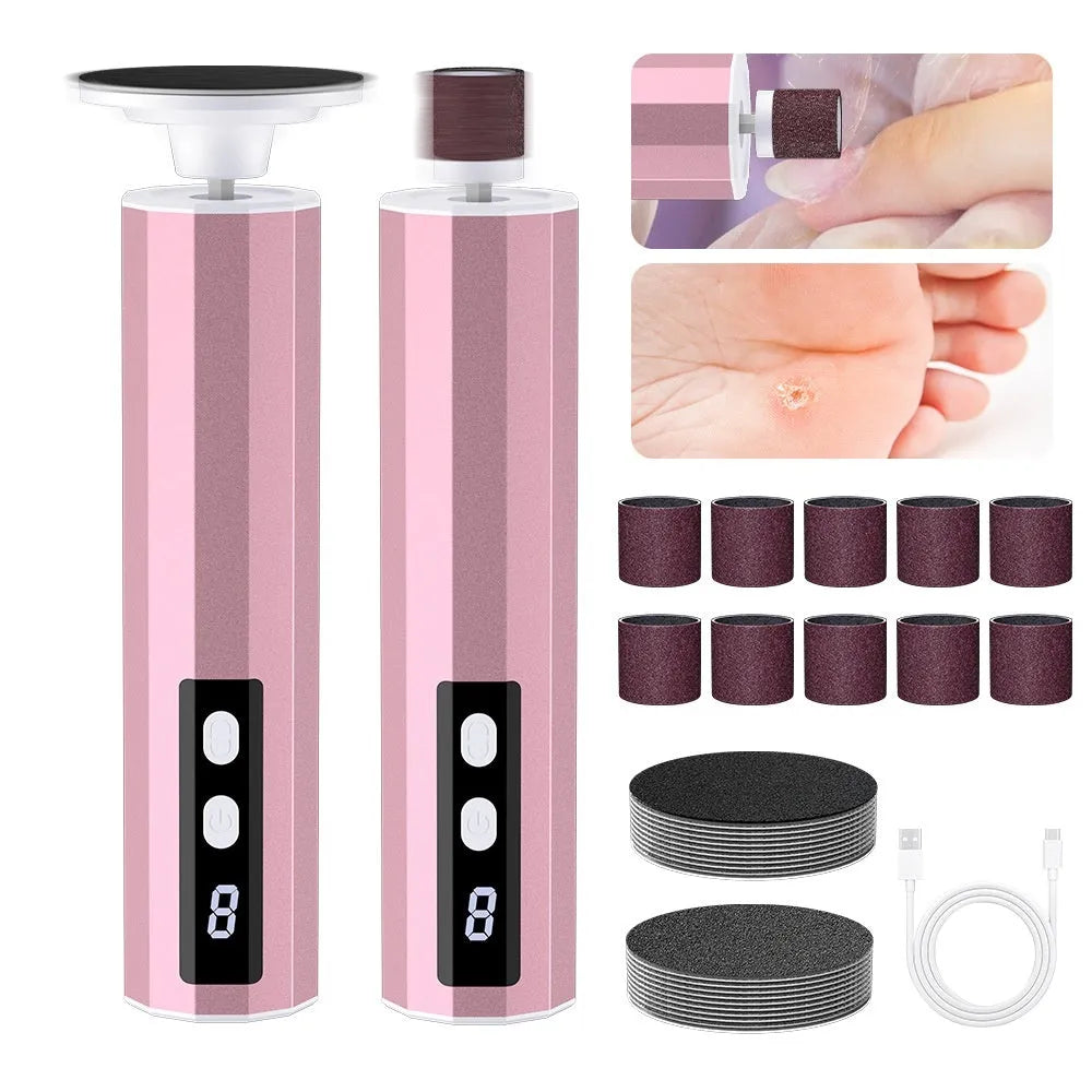 Pink electric callus remover tool with USB cable and pack of sandpaper grinding wheel attachments on a table.