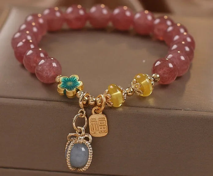 Red women's bracelet with natural strawberry quartz beads and rhinestone details on alloy setting