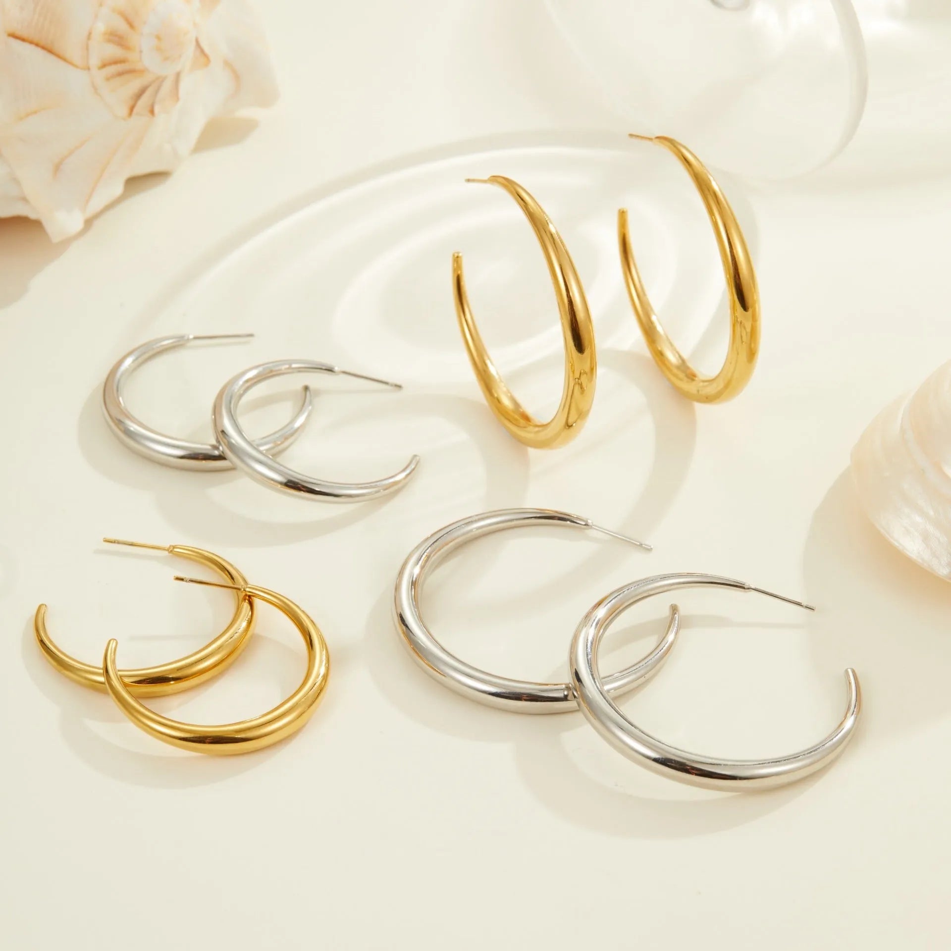 Geometric round hoop earrings in gold and steel finishes available in large and small sizes