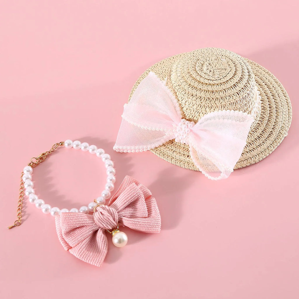 Woven Lafite leaves straw hat with pearl bow on a cat, showing pink pearl colour option in S 13cm size.