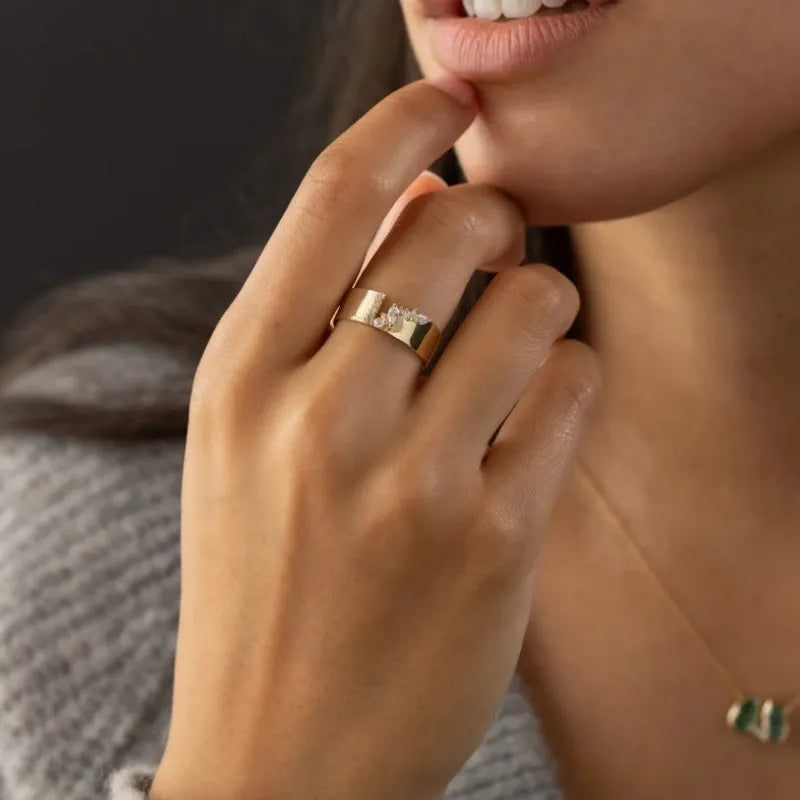 Gold electroplated copper ring with shining zircon details showing side profile view