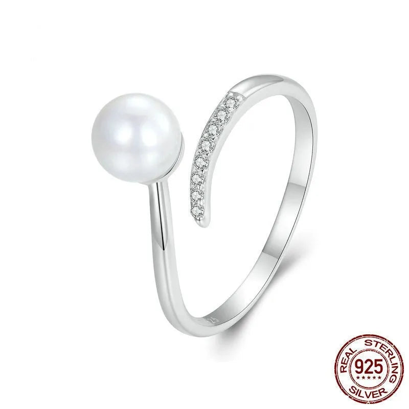 Shell pearls ring with S925 sterling silver construction and adjustable open loop design featuring natural pearl accent