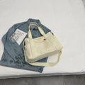 Large solid colour polyester canvas shoulder tote bag for women with internal mobile phone pocket.