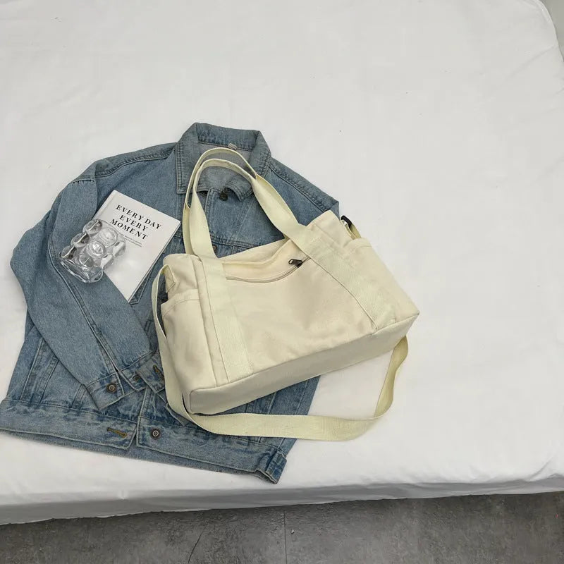 Large solid colour polyester canvas shoulder tote bag for women with internal mobile phone pocket.