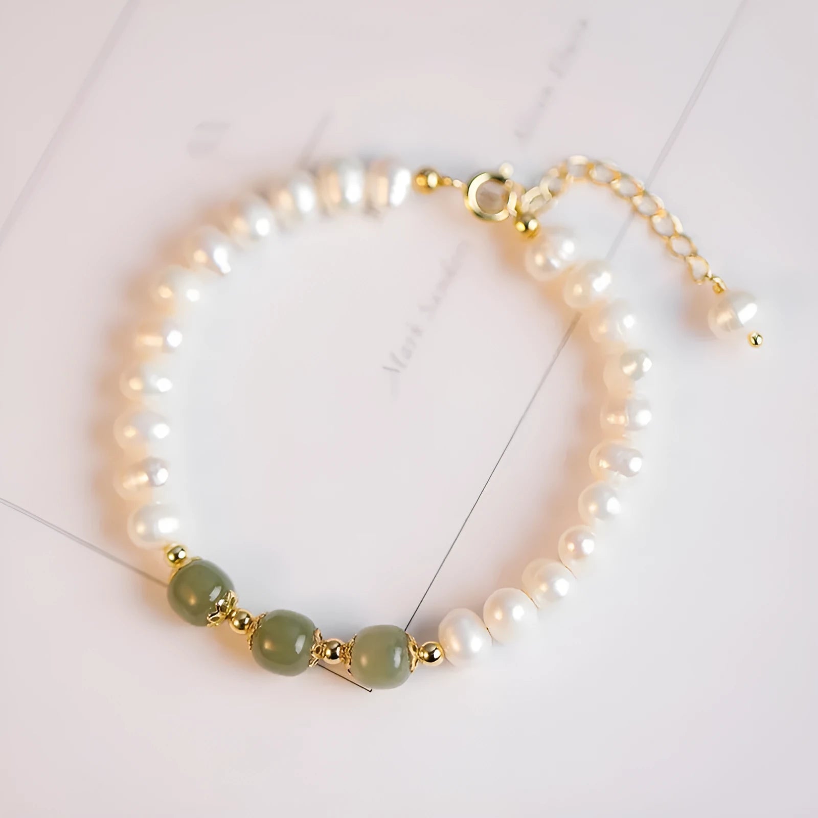 A diamond-shaped natural freshwater pearl bracelet in a Korean style, shown in deep Hetian jade colour with an electroplated finish.