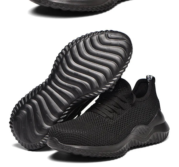 Low-cut black safety work shoes with a steel toe cap and EVA midsole on a grey background.
