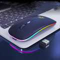 Black or white dual-mode wireless silent mouse with USB charging cable on desk