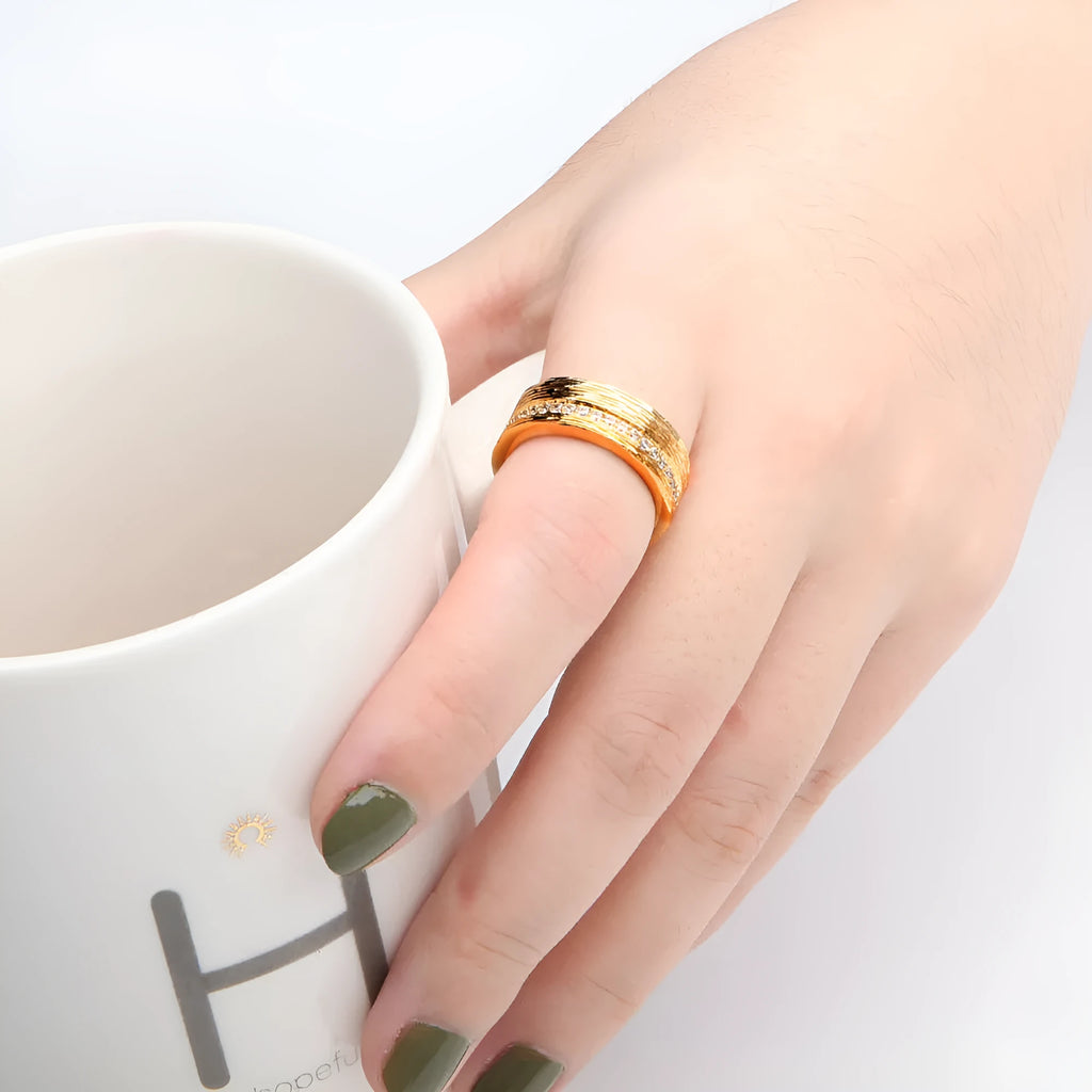 Gold geometric zircon ring on display showing angular design and available UK sizes 6-8