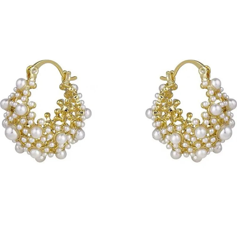 Women's gold flower basket earrings with small beads and pearl inlay detailing on copper