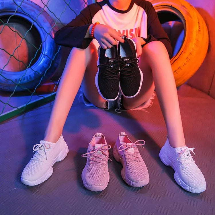 Women's white thick-soled sports shoes with flying woven upper and front strap.