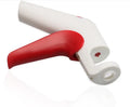Stainless steel cherry kernel remover pitter tool on a kitchen worktop