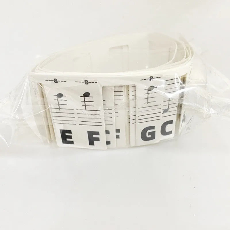 White card piano note bar stickers for 88-key keyboards with colour-coded notes and separate black note bag