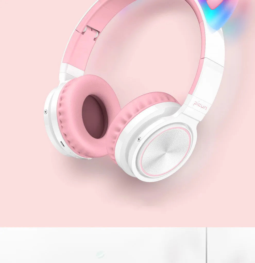 Pink and white wireless Bluetooth headphones with head-mounted design and braided cable